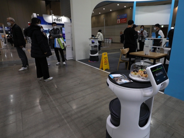 지난해 11월 25일 경기 고양시 킨텍스에서 열린 스마트상점·리테일 엑스포에서 시민들이 서빙하는 로봇을 살펴보고 있다. 사진제휴=뉴스1