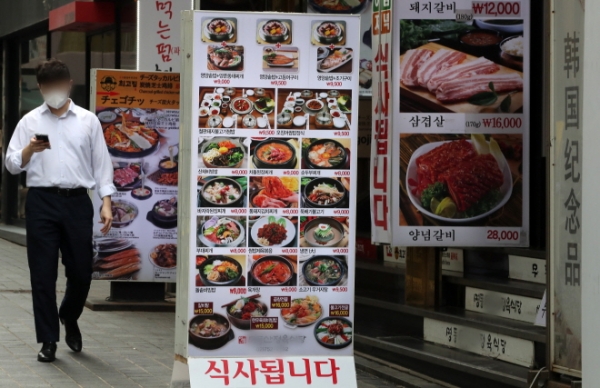 지난 6일 서울 중구 명동의 한 음식점 거리를 시민이 지나가고 있다. 사진제휴=뉴스1