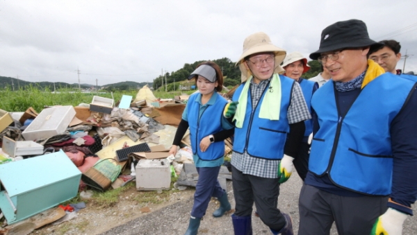 이재명 더불어민주당 대표가 지난 25일 충남 부여 정동리의 수해 피해지역을 찾아 복구작업을 나서기 위해 자리를 옮기고 있다. 사진제휴=뉴스1
